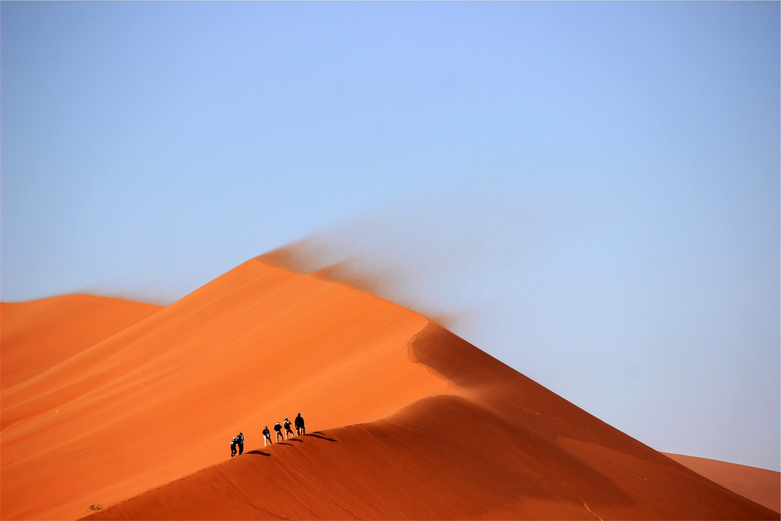 Group of People Walking on the Desert